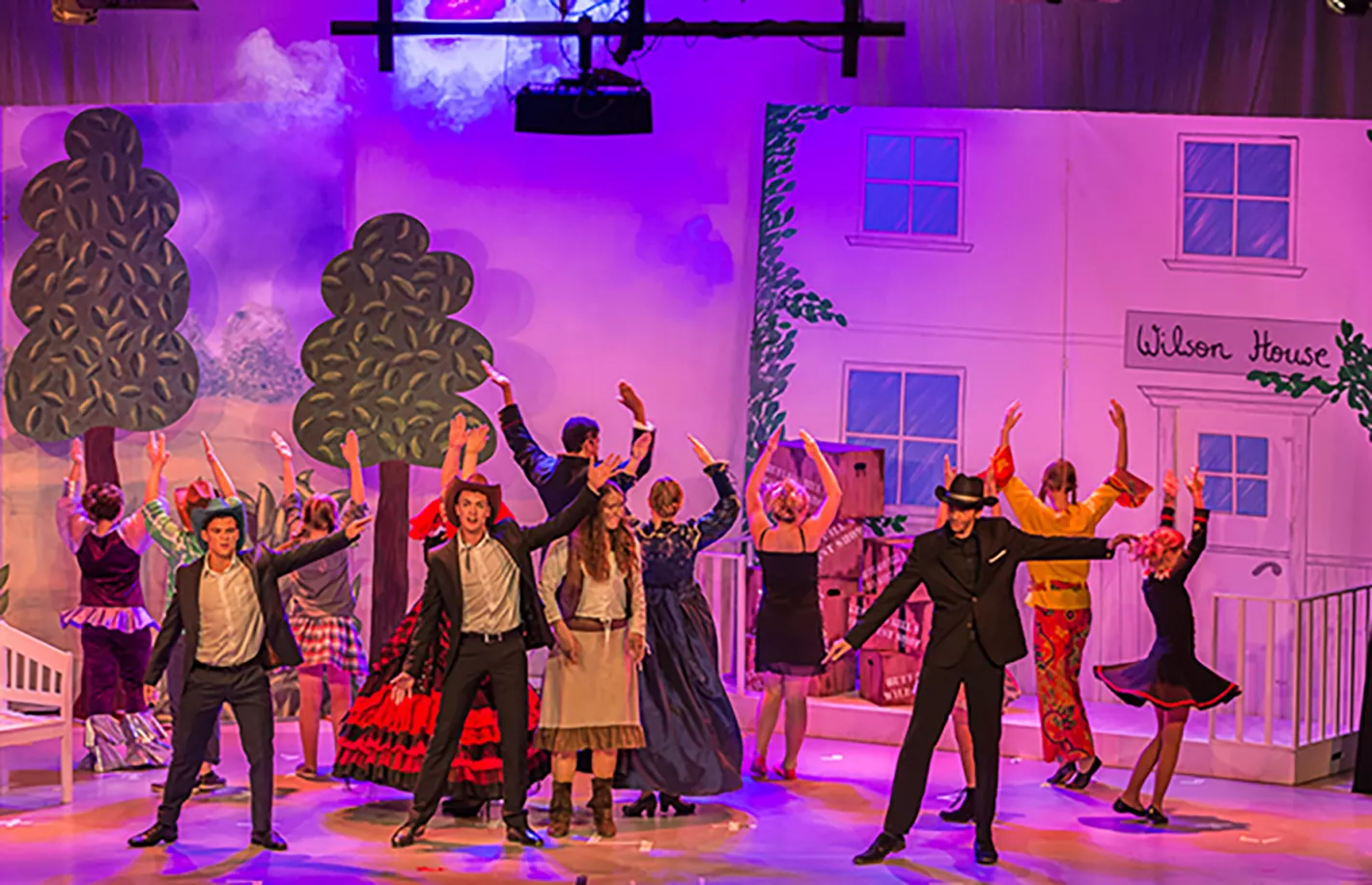 Tanzende Darsteller in eleganten Kostümen vor der Kulisse Wilson House beim Musical Annie Get Your Gun